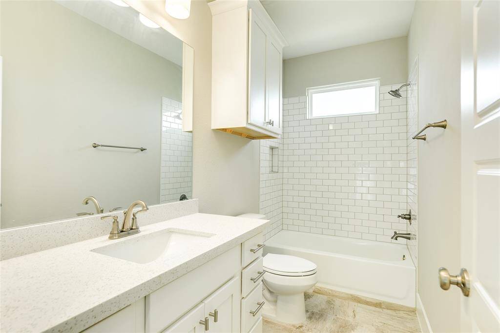 This full bath is conveniently located between two of the bedrooms upstairs and features plenty of storage.