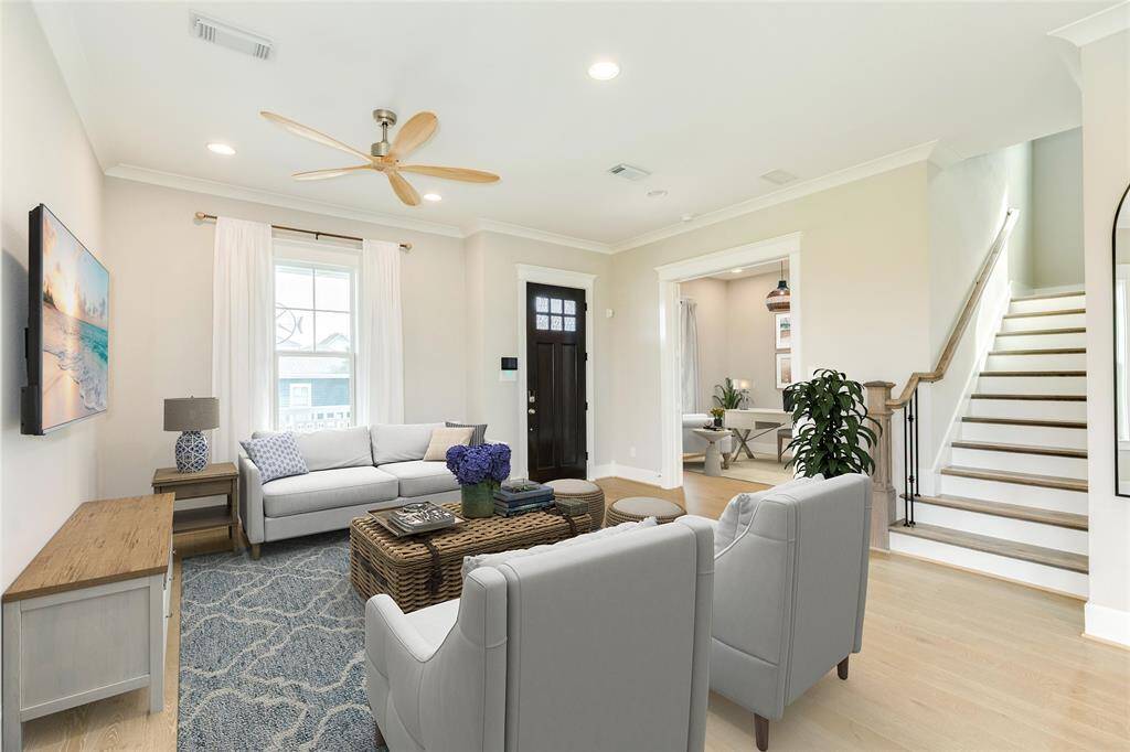 VIRTUALLY STAGED - This living space is large and inviting with high ceilings, crown molding, and lots of natural light.