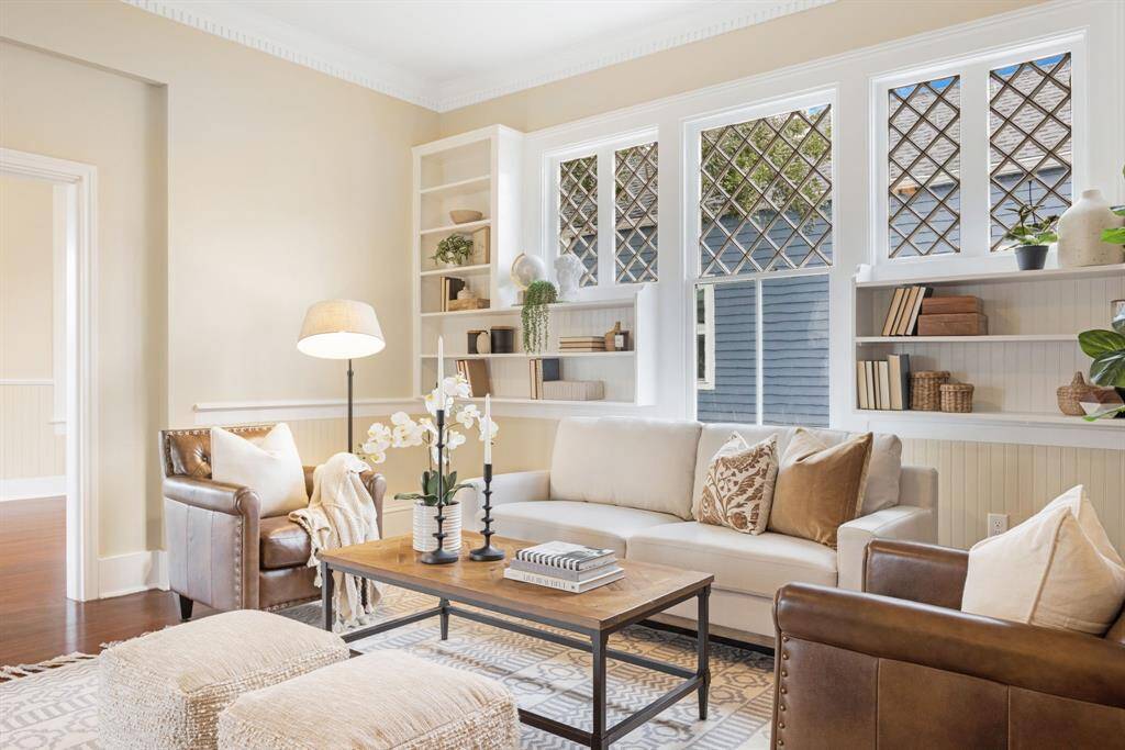 Unit 1: Character for days. From the gorgeous leaded glass windows to the wall-to-wall shelving, every detail in this living room tells a story—and invites you to write your own.