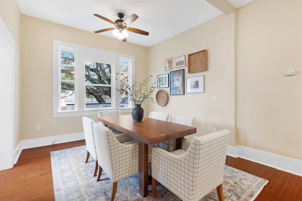Unit 1: Formal dining, island style. Gather under the glow of natural light in this airy dining room, complete with large windows, warm hardwoods, and plenty of room to host friends and family.