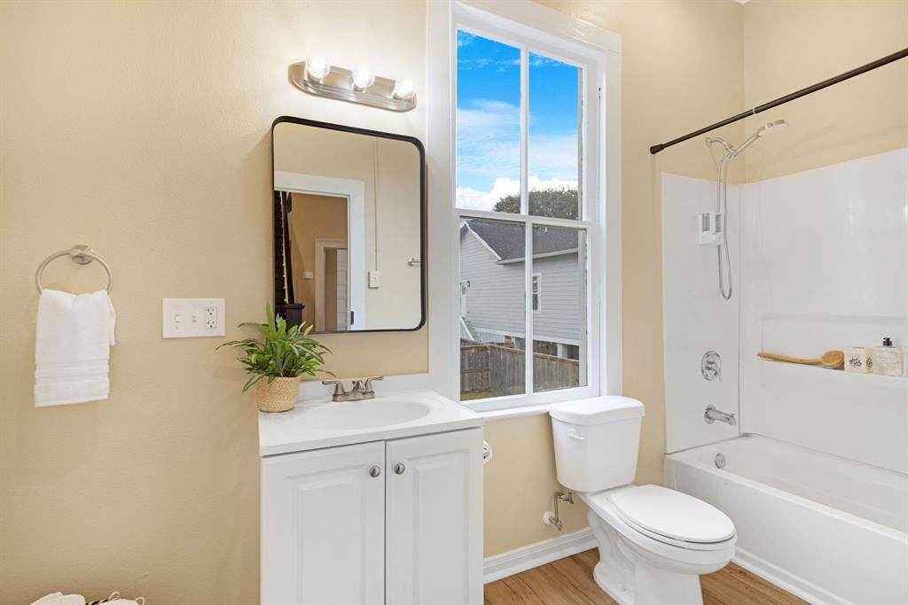 Unit 1: Spa-like simplicity. Crisp, clean, and filled with natural light—this downstairs full bathroom is both practical and peaceful, featuring a tub/shower combo and modern finishes.