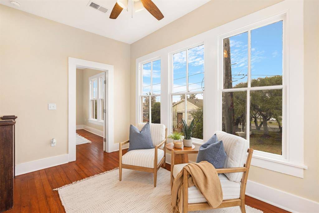 Unit 1: Coastal charm with a view. This upstairs sitting area offers panoramic views and dreamy natural light—your personal escape just steps from the primary bedroom.