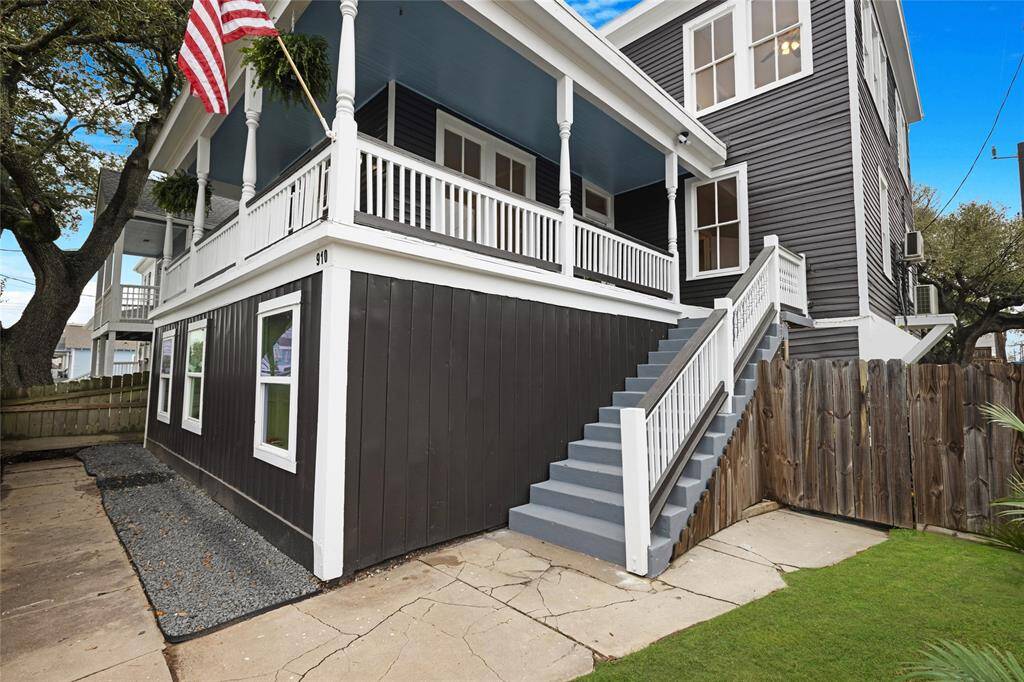 Easy access to Unit 1 from the side stairway. The inviting front porch, crisp white trim, and dreamy dark exterior make this one stand out in all the best ways. It's a true Galveston gem — inside and out.