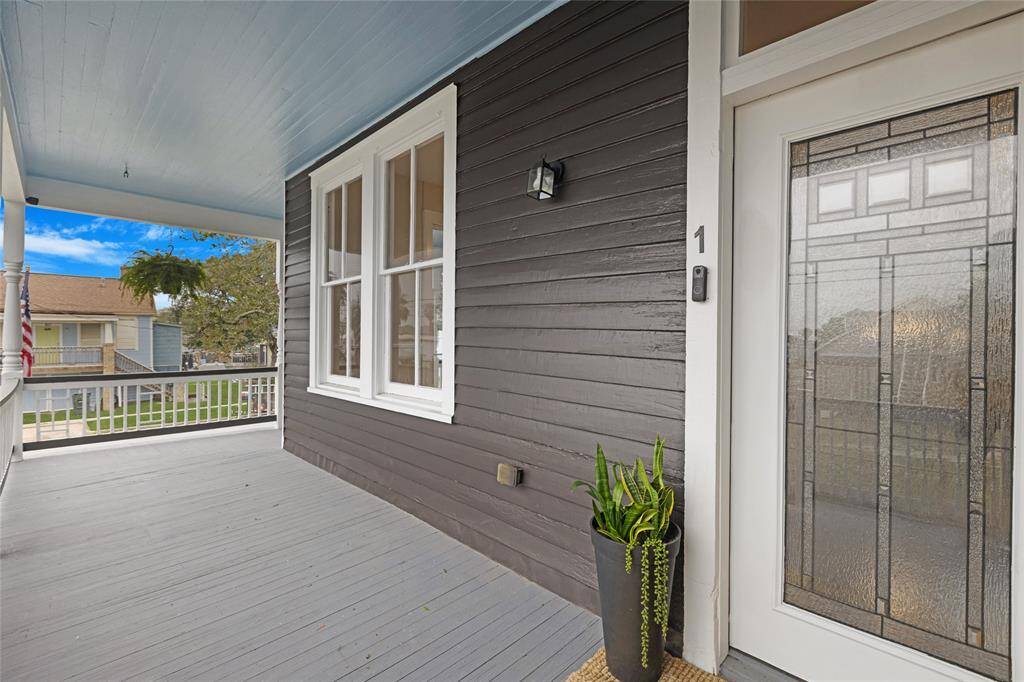 The little details make all the difference — crisp trim, a pop of blue overhead, and a front porch that practically begs for a welcome mat. That leaded glass door is just the beginning of the style you’ll find inside.