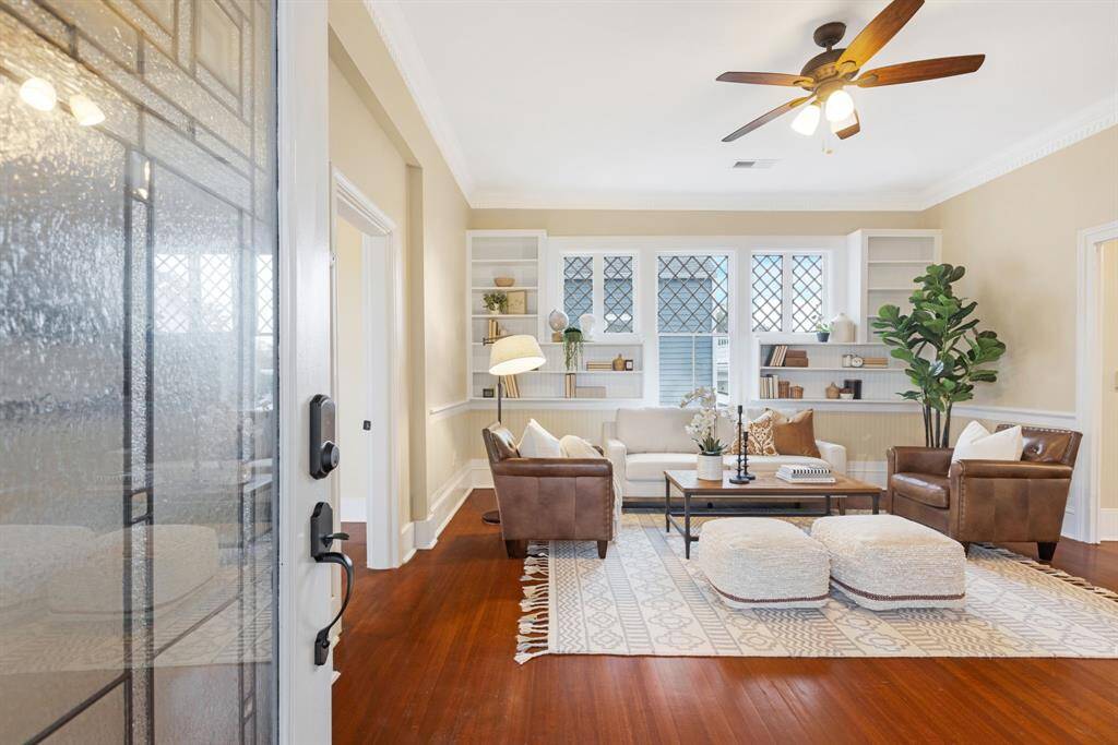Unit 1: Welcome home. Step through the front door into a sun-drenched living room filled with warmth, character, and vintage charm. Beautifully refinished hardwood floors and soft natural light greet you the moment you arrive.