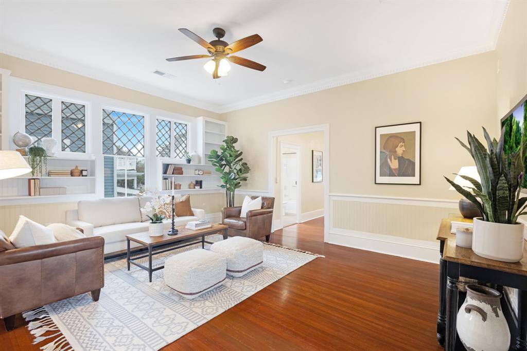 Unit 1: Inviting living space. This stunning space features custom built-ins, crown molding, and rich wood tones that blend timeless character with updated comfort. The perfect place to gather, unwind, or entertain.