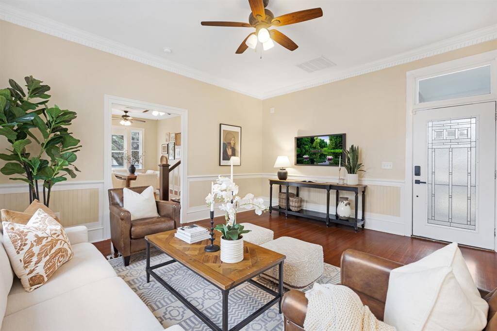 Unit 1: Light, bright & beautiful. Oversized windows and neutral tones make this living area feel like a breath of fresh air. Notice the elegant ceiling fan and thoughtful touches throughout.