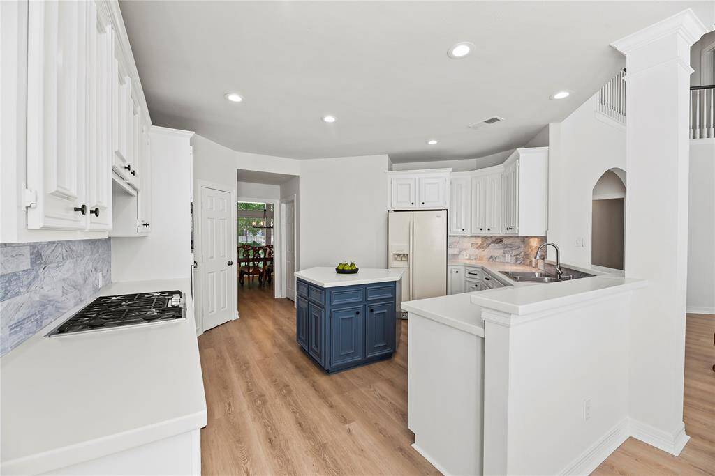Imagine baking sugar cookies in the attractive and updated kitchen. Use the center island as a place to cut and decorate seasonal cookies with all sorts of sugar, sparkles, and candy!