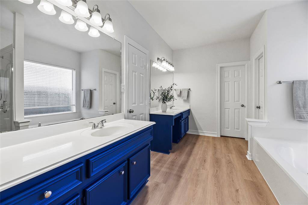 Dual sinks ensure both partners have a dedicated area for grooming and self-care! Ample counter space is only enhanced by the tremendous space beneath, which includes multiple drawers of varying sizes and base storage cabinetry!
