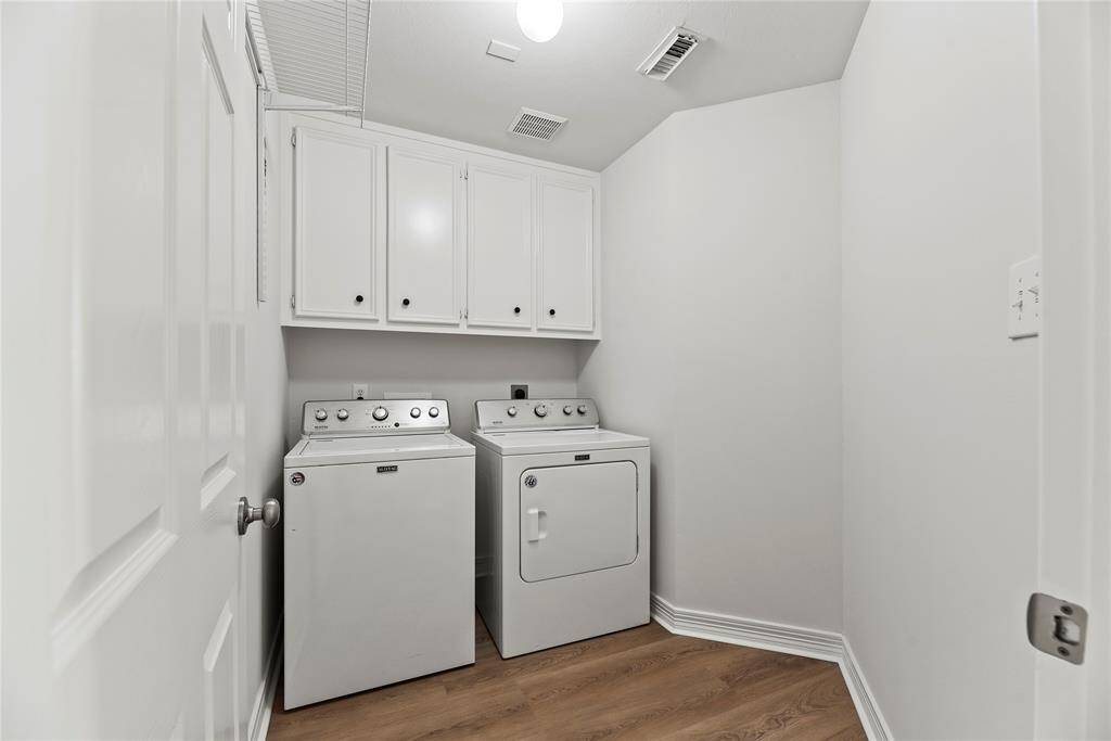 Directly off the kitchen, the laundry room features cabinetry for detergents, fabric softeners, bleach, dryer sheets, and other essentials!