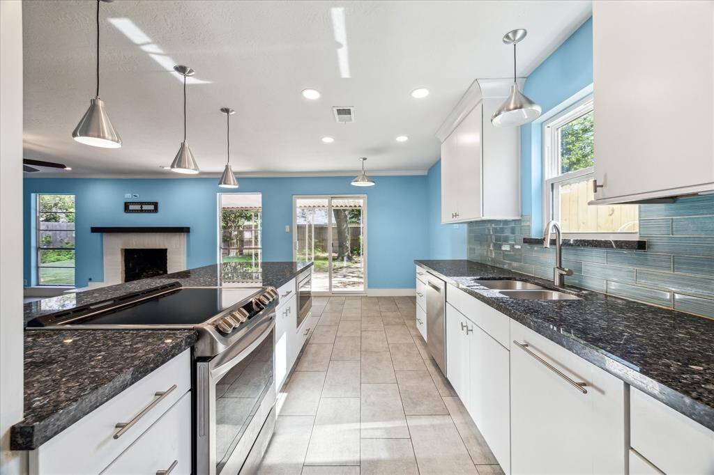 Elegant glass tile backsplash and contemporary fixtures.