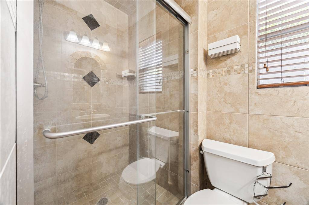 Custom tile walk-in shower in primary bath.
