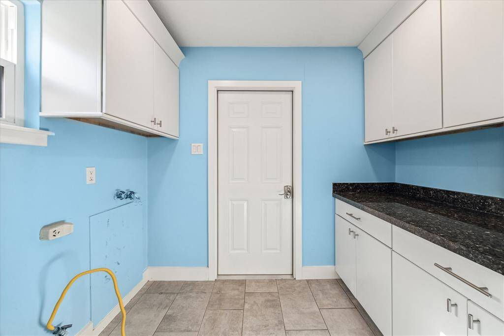 Laundry/mud room with extra storage and counter space.