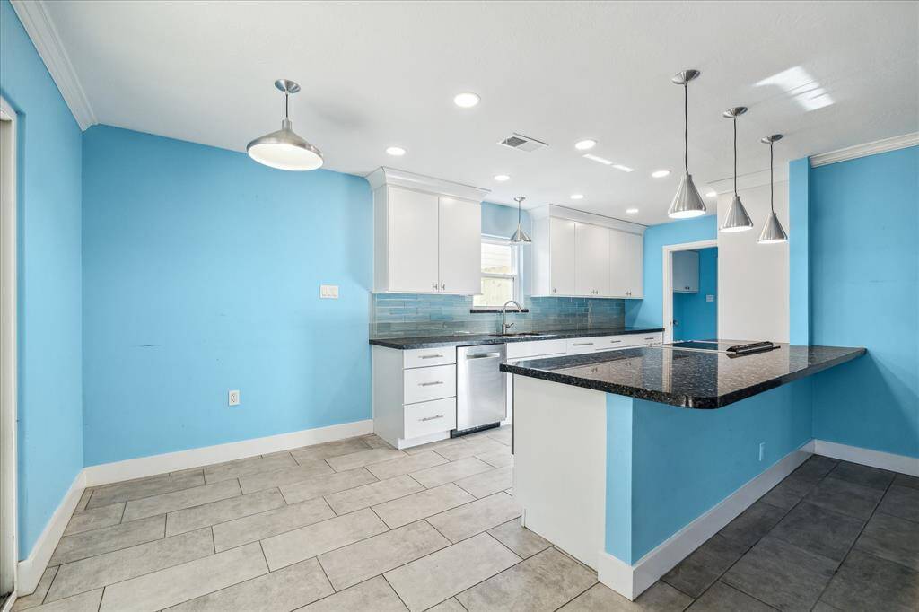 Beautifully updated kitchen with contemporary cabinets and black granite countertops.