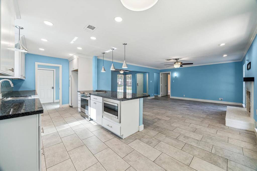 Entertain and indulge your inner chef in this luxurious open kitchen with updated stainless appliances.