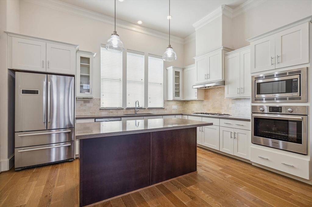 A chef's dream! Well-lit open Kitchen is perfect for entertaining featuring a large quartz island with breakfast bar seating, SS appliances & a large WALK IN pantry. Fridge STAYS!