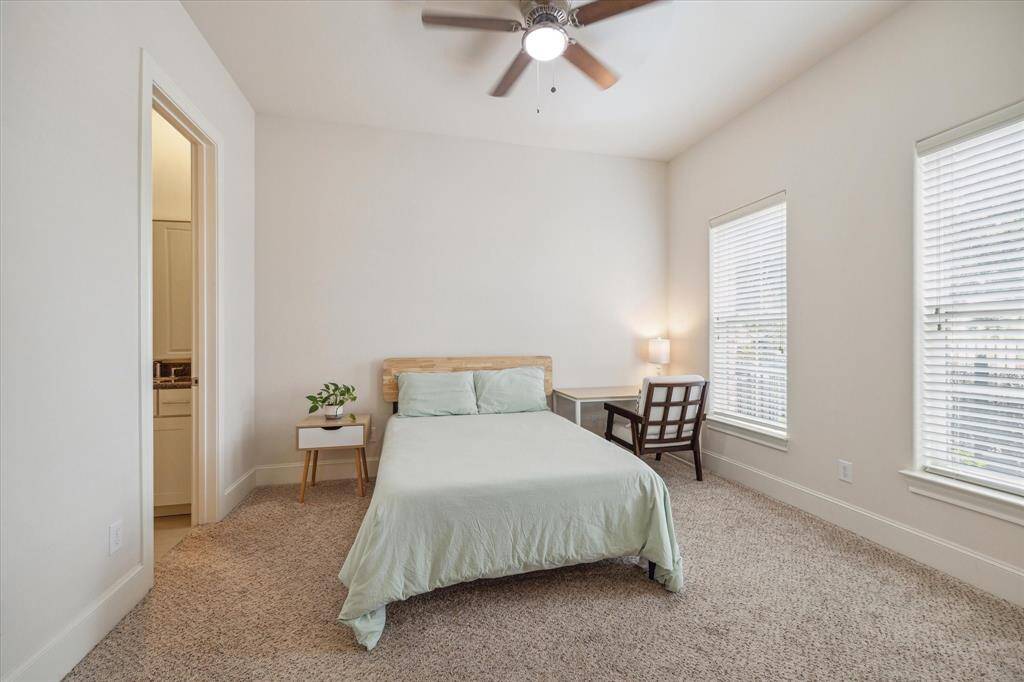 Downstairs bedroom features carpeted floors & a large walk in closet.