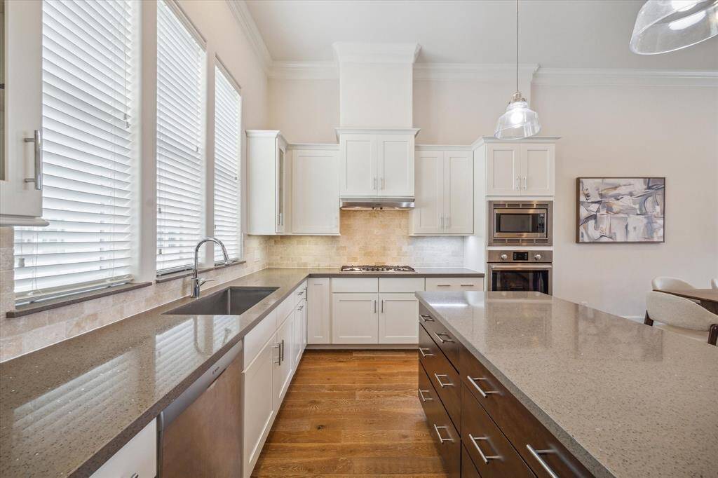 The Kitchen has 42 inch cabinets with undercabinet lighting highlighting the neutral upgraded backsplash. Outlets are hidden underneath the cabinets, leaving the elegant backsplash uninterrupted.