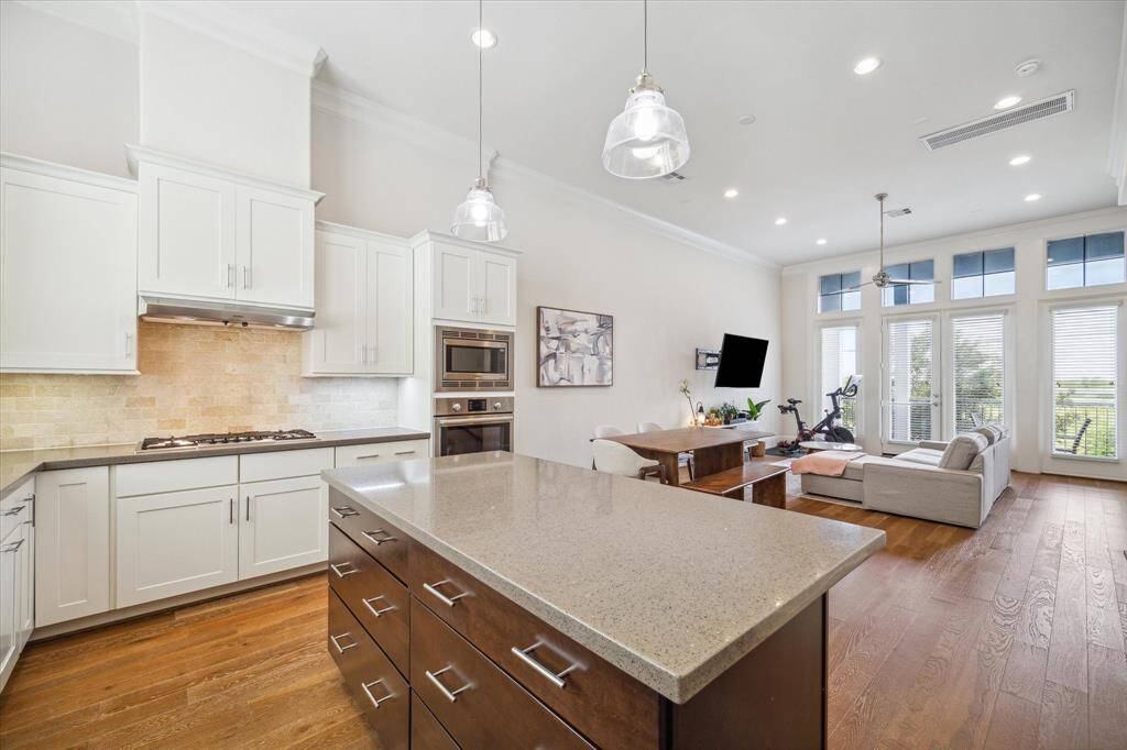 The Kitchen, the main hub of the home, shows off the ideal open concept allowing you not to miss a second of action. The Dining Space is located straight ahead.