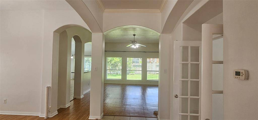 View of the architectural arches adds a bit of elegance to this home with high ceilings