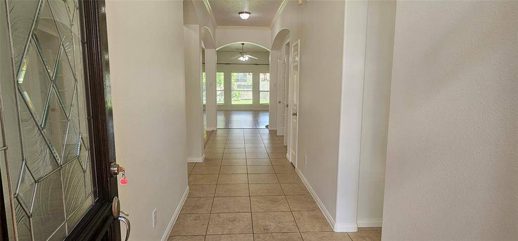 As you come through the front door, you are greeted with a welcome invitation into your home to guide you through the architectural arches into the living area.