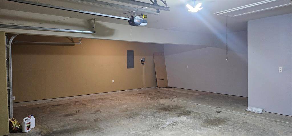 3rd bay of the garage has interior fuse box and sprinkler system panel. the garage also has additional space for storage.