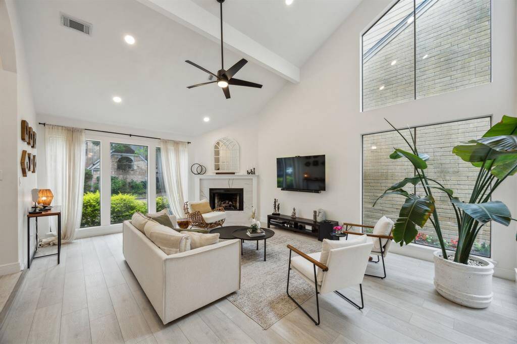 Another view of the living room featuring abundant natural light.