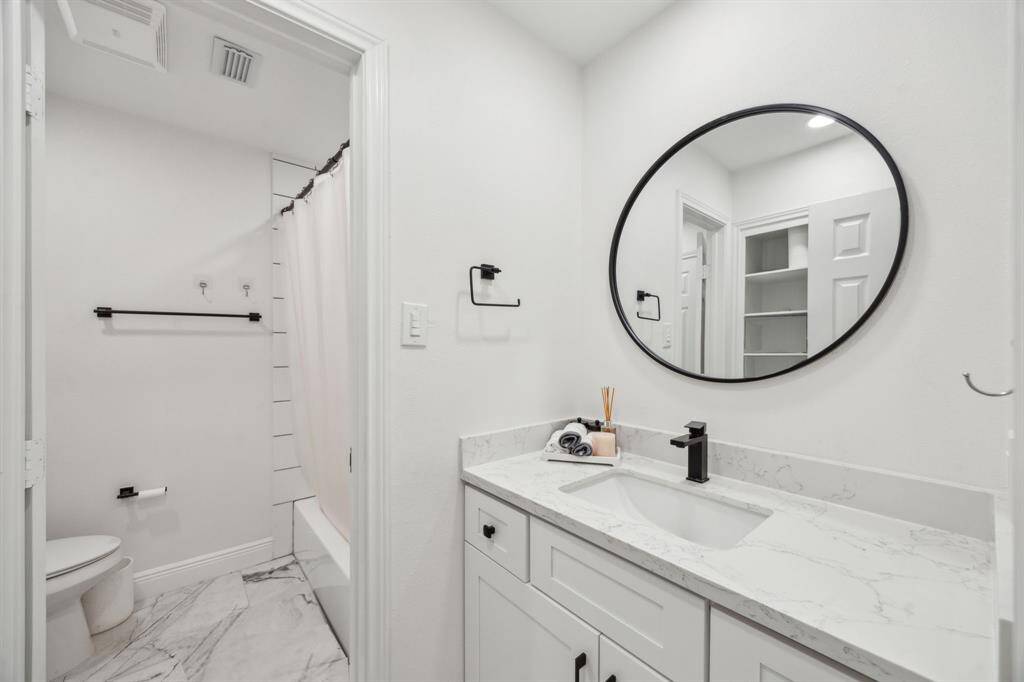 Shared bath features Quartz countertops, beautiful tile floors, and a tub/shower combo.