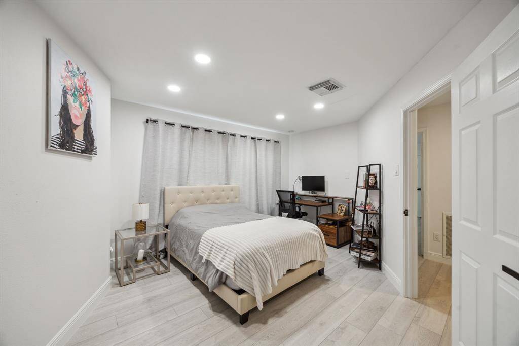 Another guest bedroom with recessed lighting and walk-in closet.