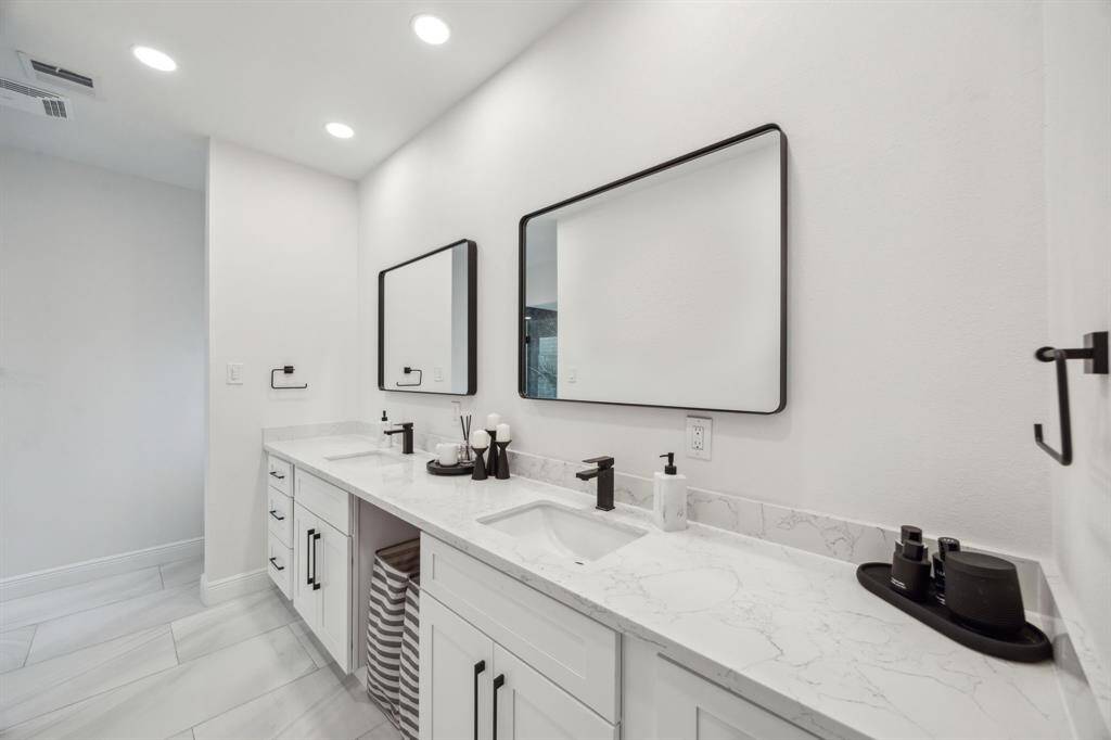 Upgraded primary bath features recessed lighting, and quartz countertops.