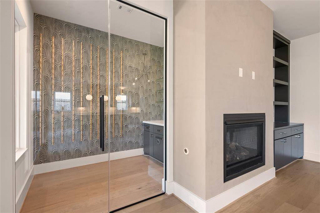 To the left of the fireplace is a glass walled wine room.  What a nice feature!