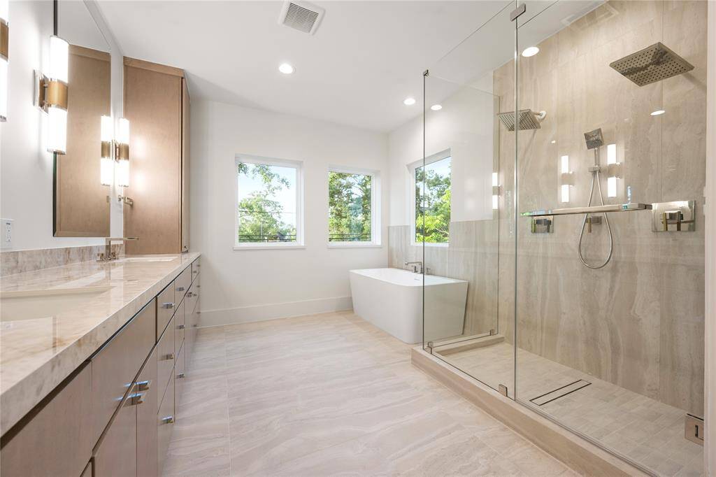 The Primary spa-like Bathroom is accentuated with sand colored tile providing a relaxing ambiance.