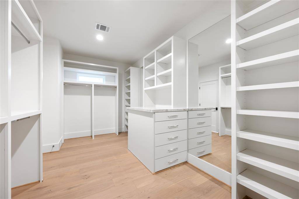 Closet space with natural light and well appointed storage and shelving