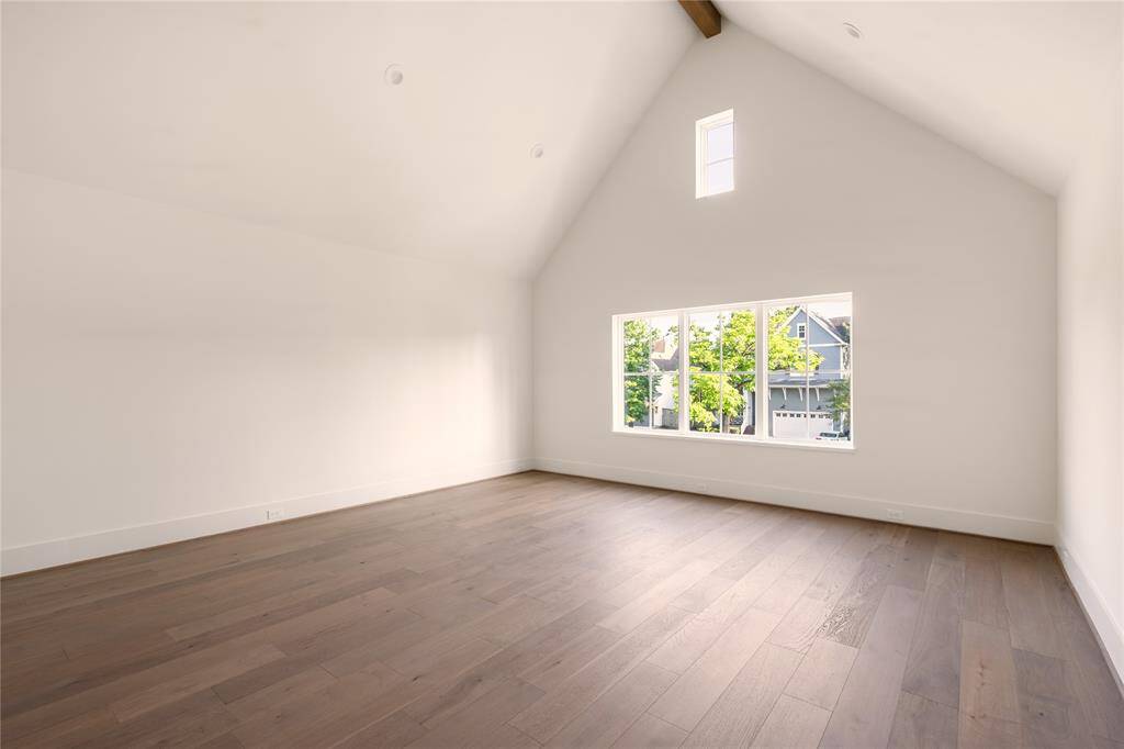 Large upstairs game room with cathedral ceilings and doors offering the ability to close off if things are too loud from all the fun.