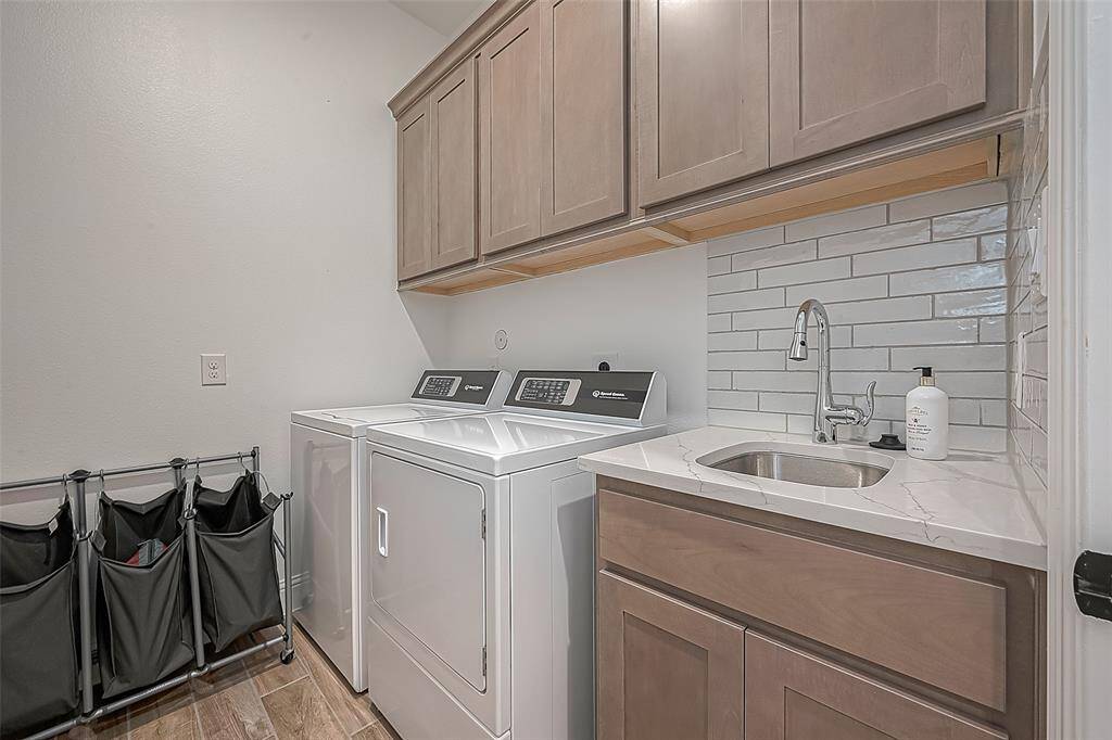 Stylish laundry room with a convenient sink and ample storage.