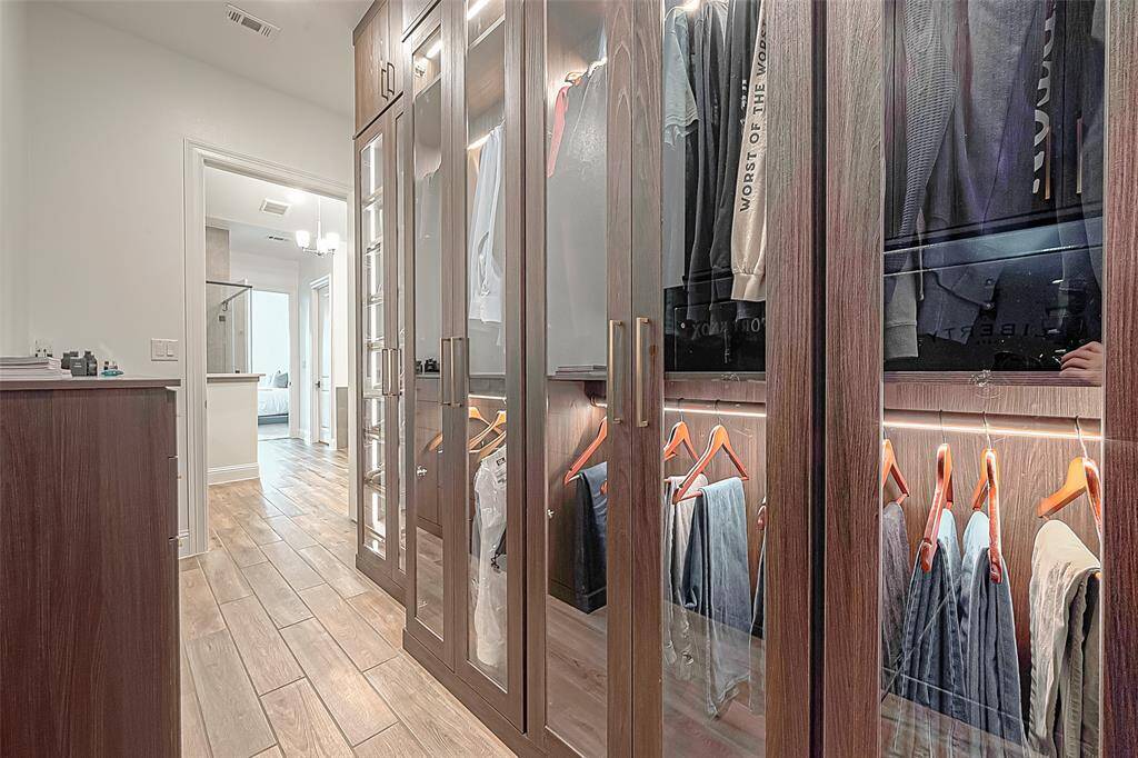 Discover the ultimate in organization with this spacious, custom double walk-in closet, perfect for keeping your wardrobe elegantly arranged.