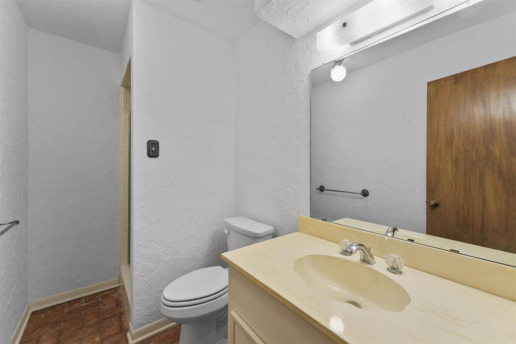 This secondary bath is located right next to bedroom 2, offering a glass door standing shower, and a convenient guest bathroom tucked away form the kitchen.