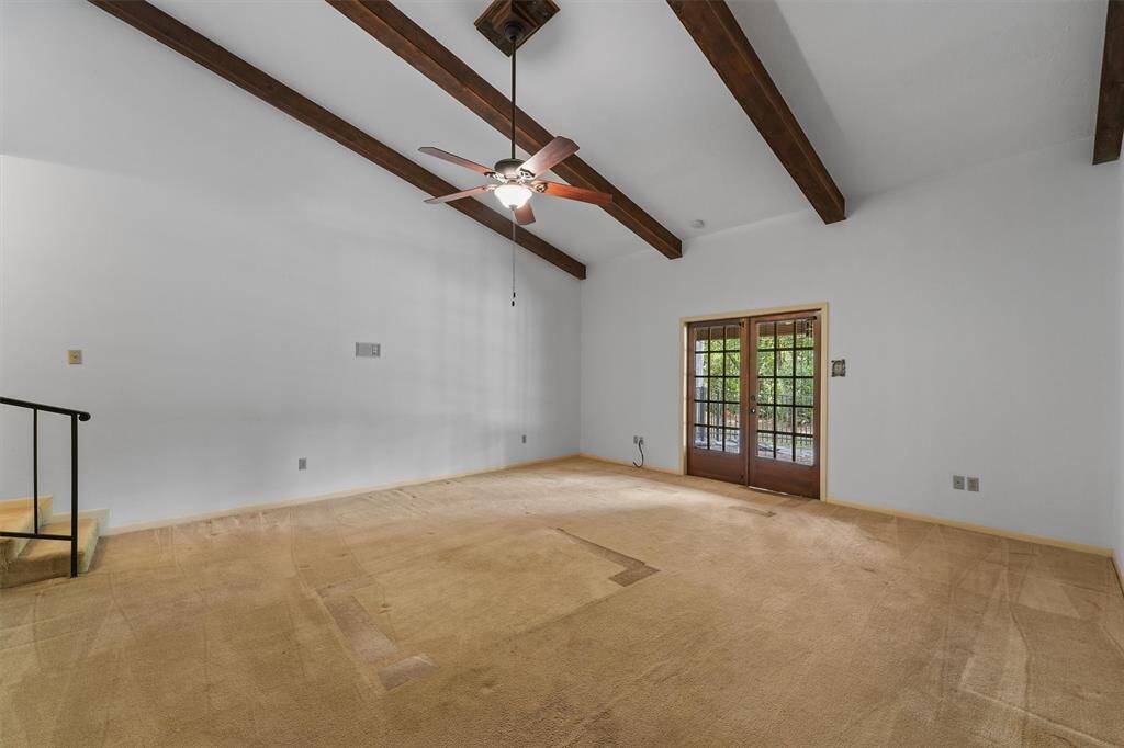 The Primary Suite is one of the largest you will find! Two separate closets flank both sides of the room, and Double Doors look out across the outdoor deck with an expansive view of Little Lake. Vaulted Ceilings with Wood Beam details add to the grand feel.