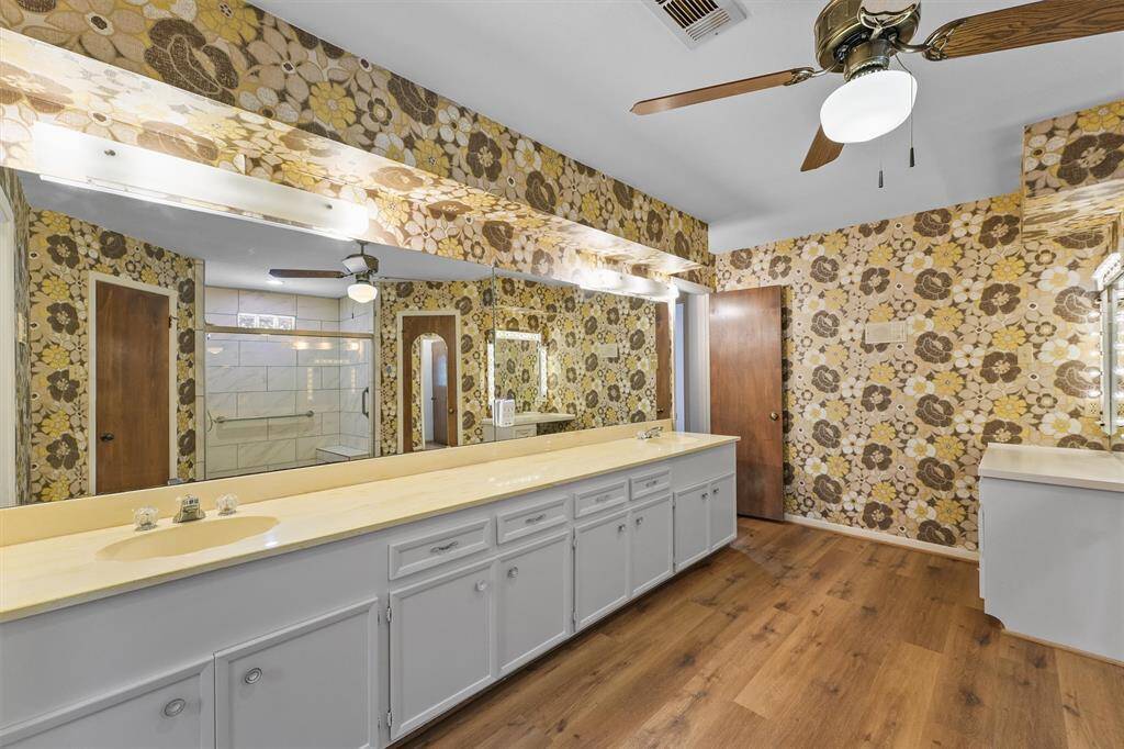 The Master Bathroom has SO much potential! Double sinks, expansive cabinets, and a separate Vanity with custom lighting.