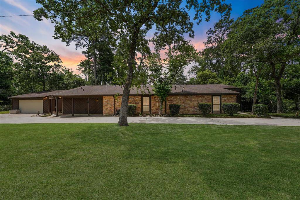 This is a sideview of the home, you can see the long driveway leading back the the side entry detached garage which is tucked behind the house.