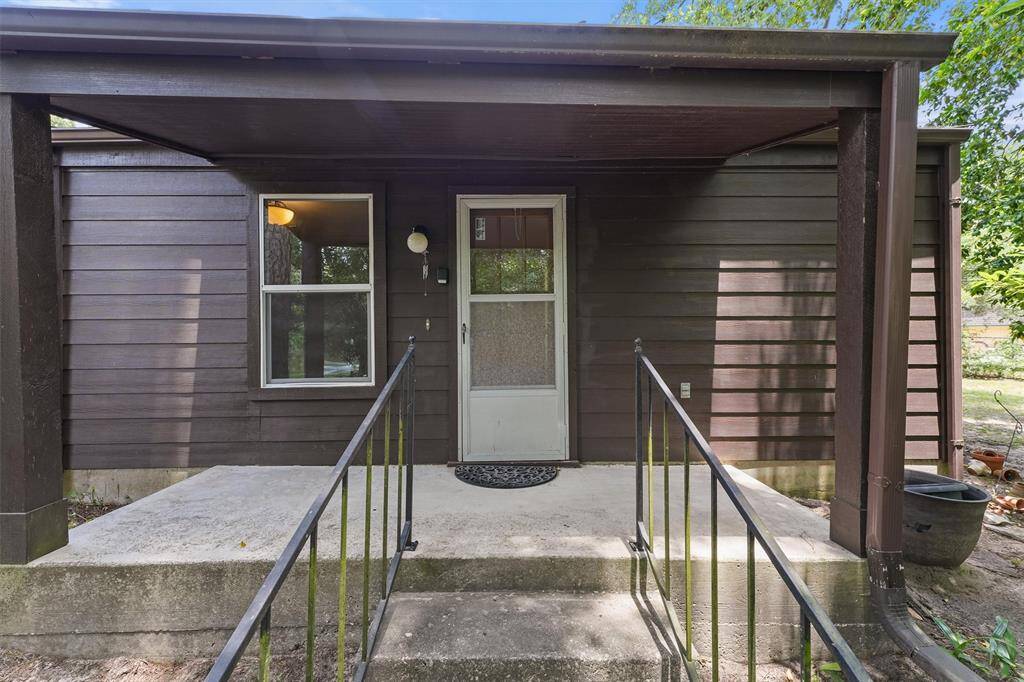 Next to the main house, is a Detached Garage with a Garage Apartment/Guest Quarters. This Patio is nestled behind a nice wooded portion of the lot with a path directly to the lake.