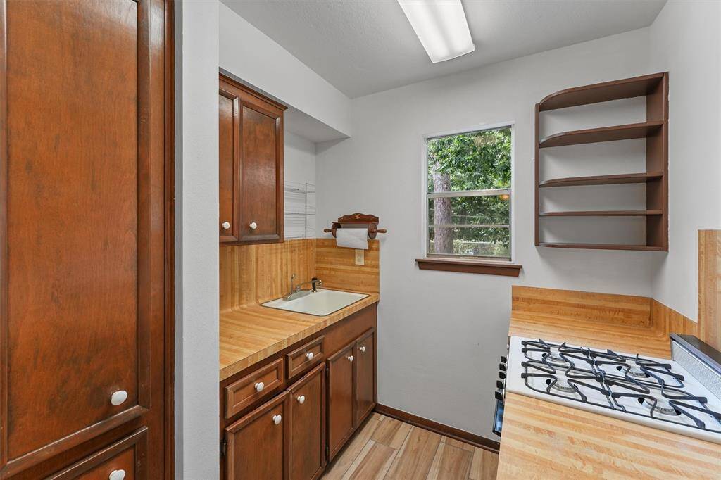 The Kitchenette in the Garage Apartment complete with a gas range and extra storage.