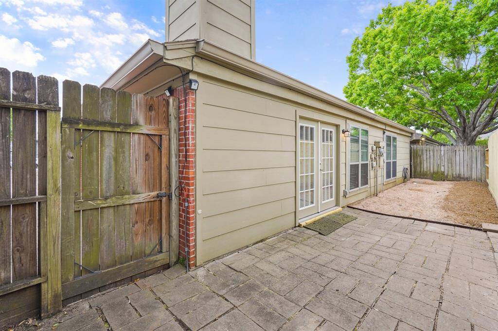 The backyard includes a large paved patio that's the perfect area for an outdoor living space, grill and patio furniture! The french doors lead to the large family room and kitchen making easy to entertain.