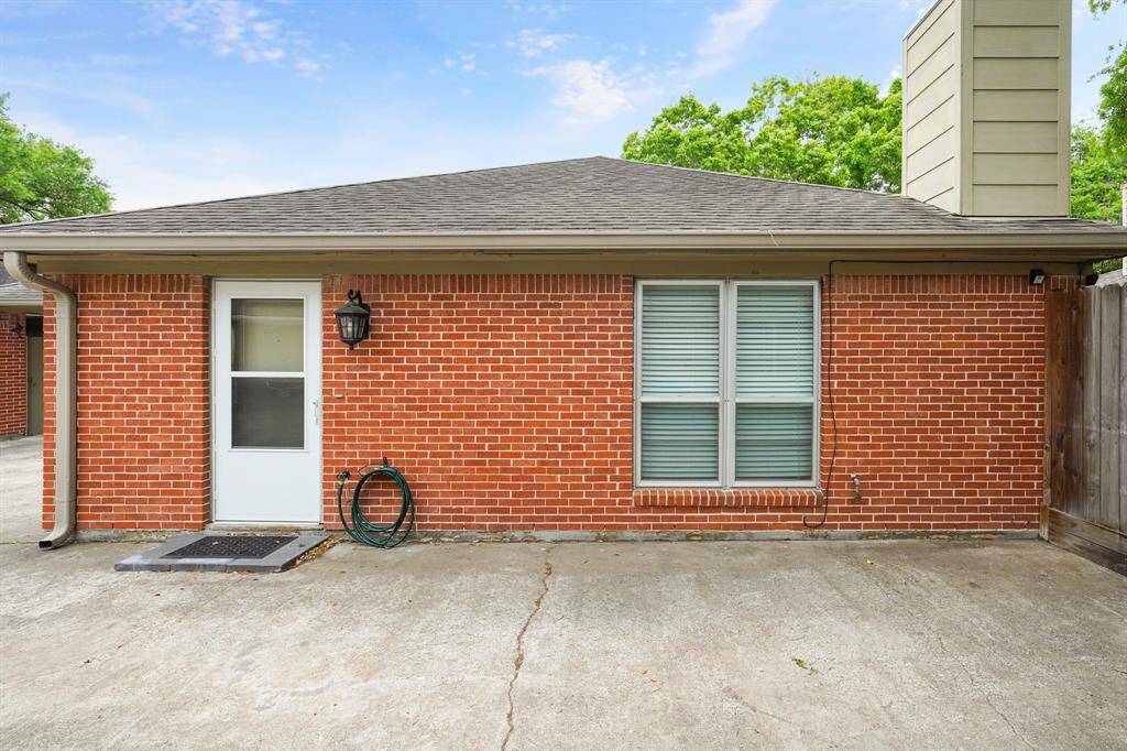 Welcome home to 10834 Lynbroook! Approaching the front door you are greeted by a warm brick exterior and extended concrete patio!