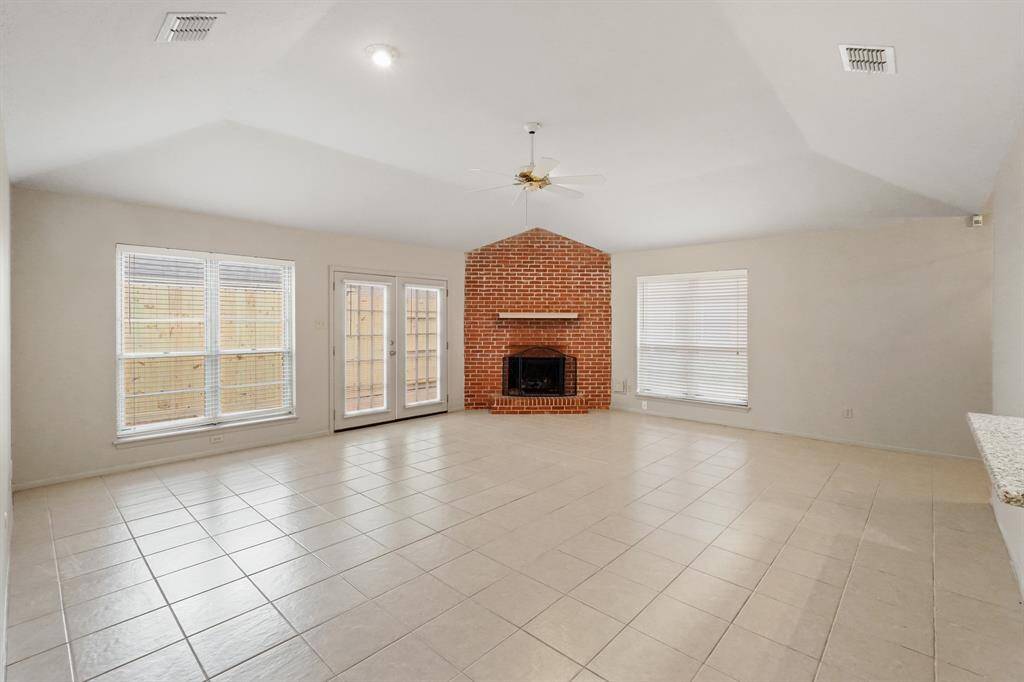 Gather your family and guests together in your huge family room! Featuring vaulted ceilings, brick fireplace fresh paint, ceramic tile floors, and large windows letting in tons of natural light!
