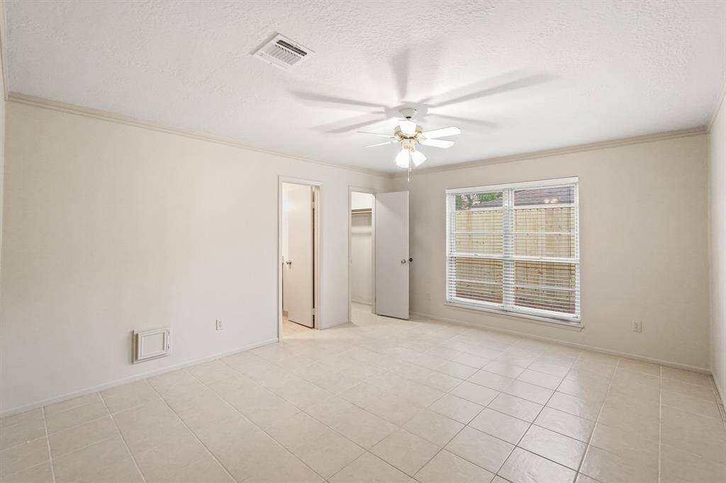 The primary bedroom welcomes you with bright natural light, fresh paint, ceiling fan, and ensuite bathroom! Plus the neutral ceramic tile throughout the room makes it easy to clean and maintain.