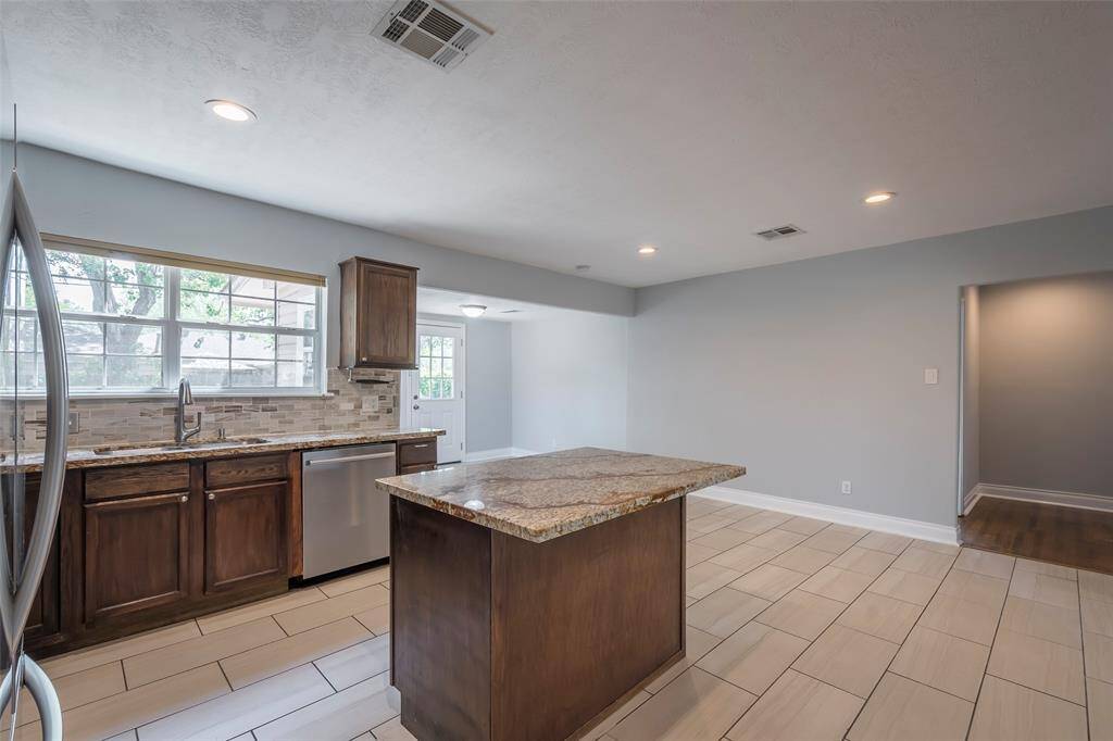 The open floor plane with all of the windows make for a living area with an abundance of natural light. Dishwasher was replaced in 2022.