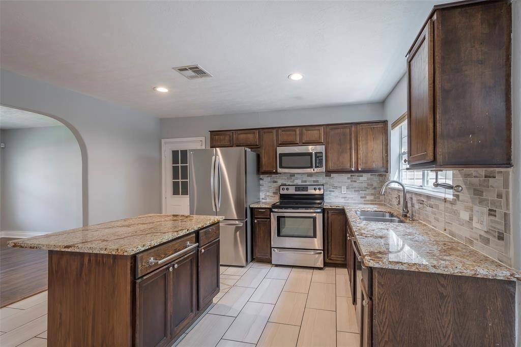 Plenty of cabinet and counter space with subway tile backsplash and stainless appliances. Refrigerator was installed in 2022.