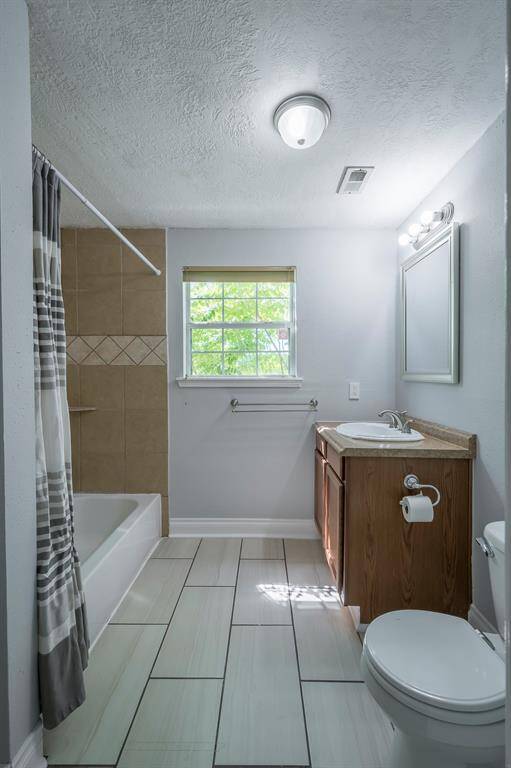 This is the second bath on the first floor that features a tub/shower combo and single vanity.
