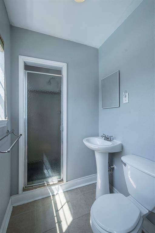 The 3rd bath upstairs features a pedestal sink and shower.